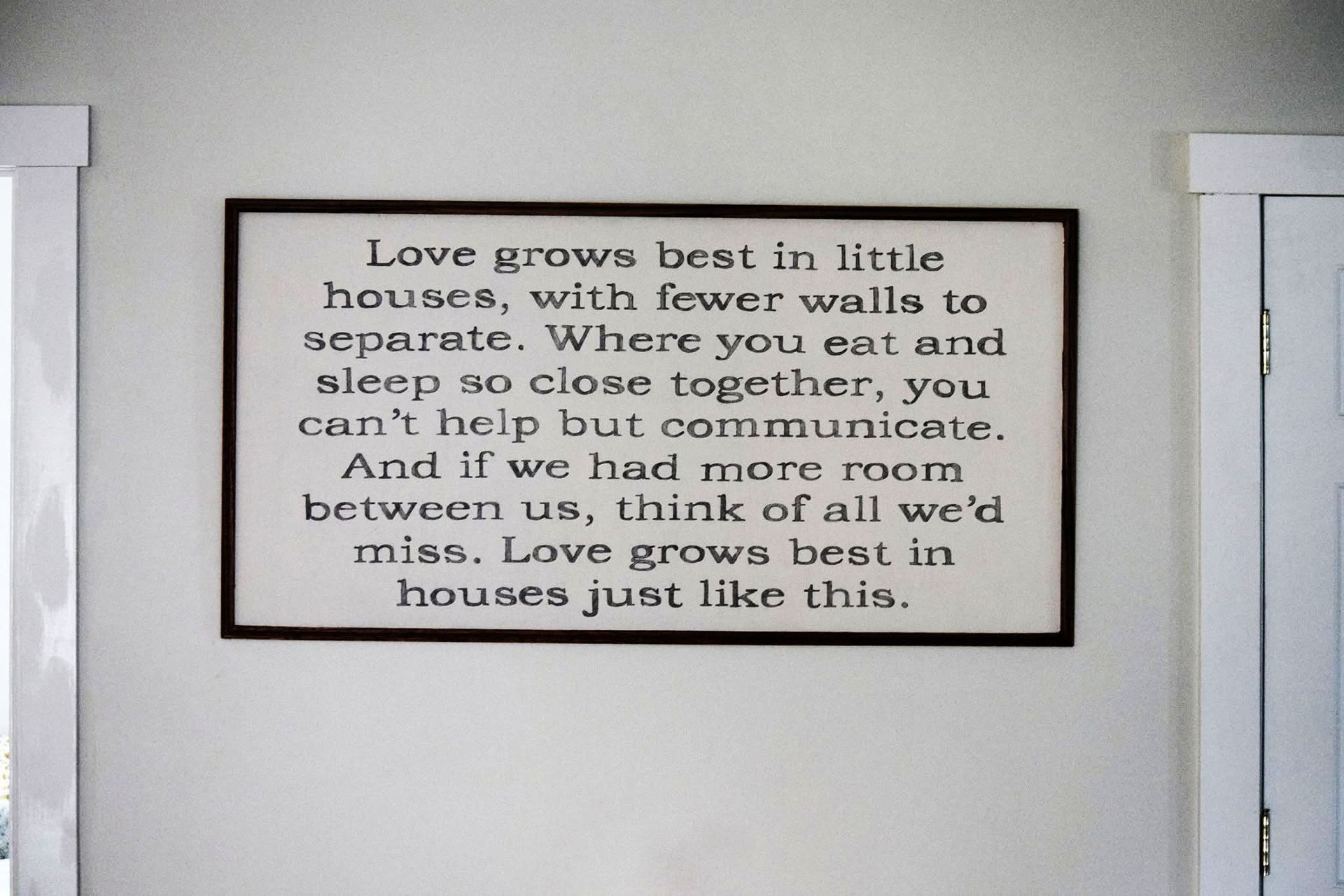 A sign that says love grows best in little houses