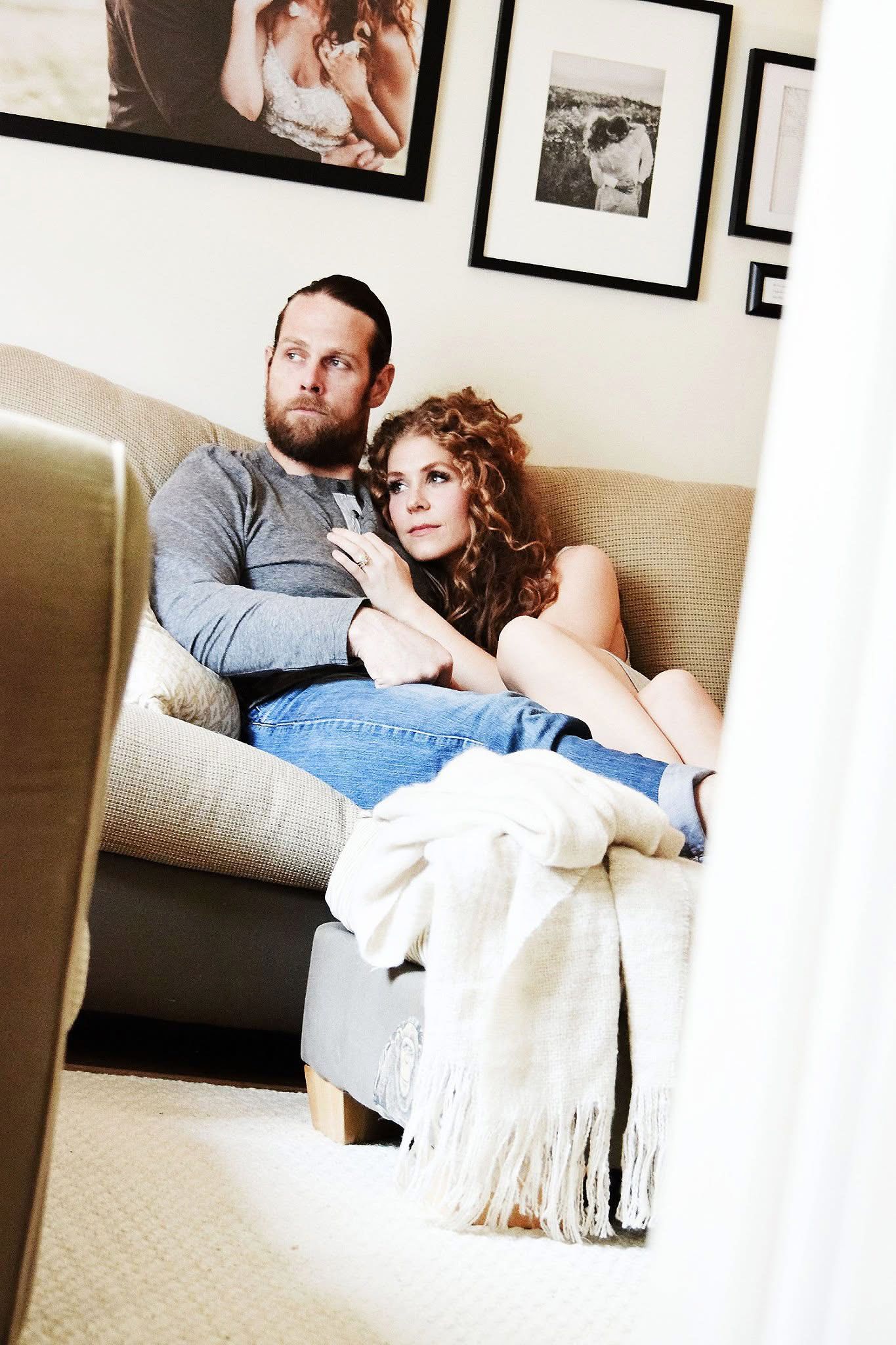 A man and a woman are sitting on a couch