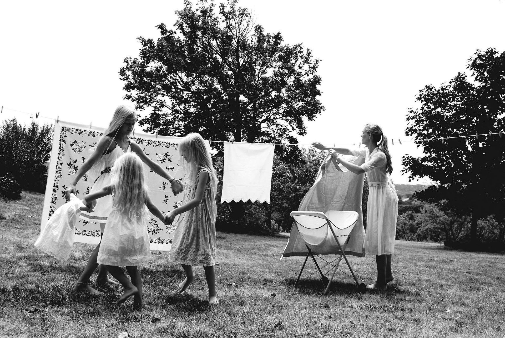 A black and white photo of a group of girls holding hands