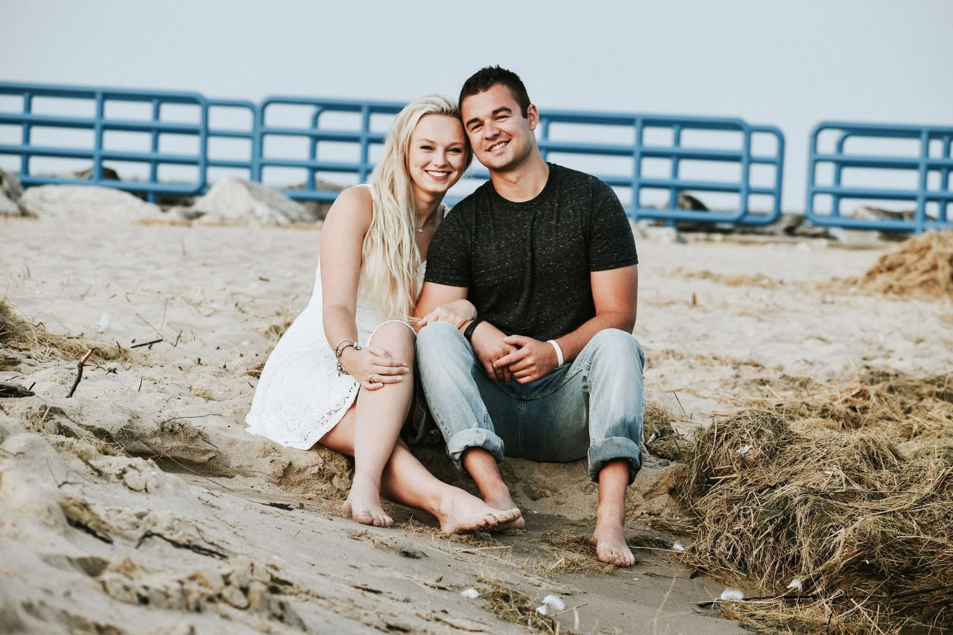 A man and a woman are sitting on the beach.