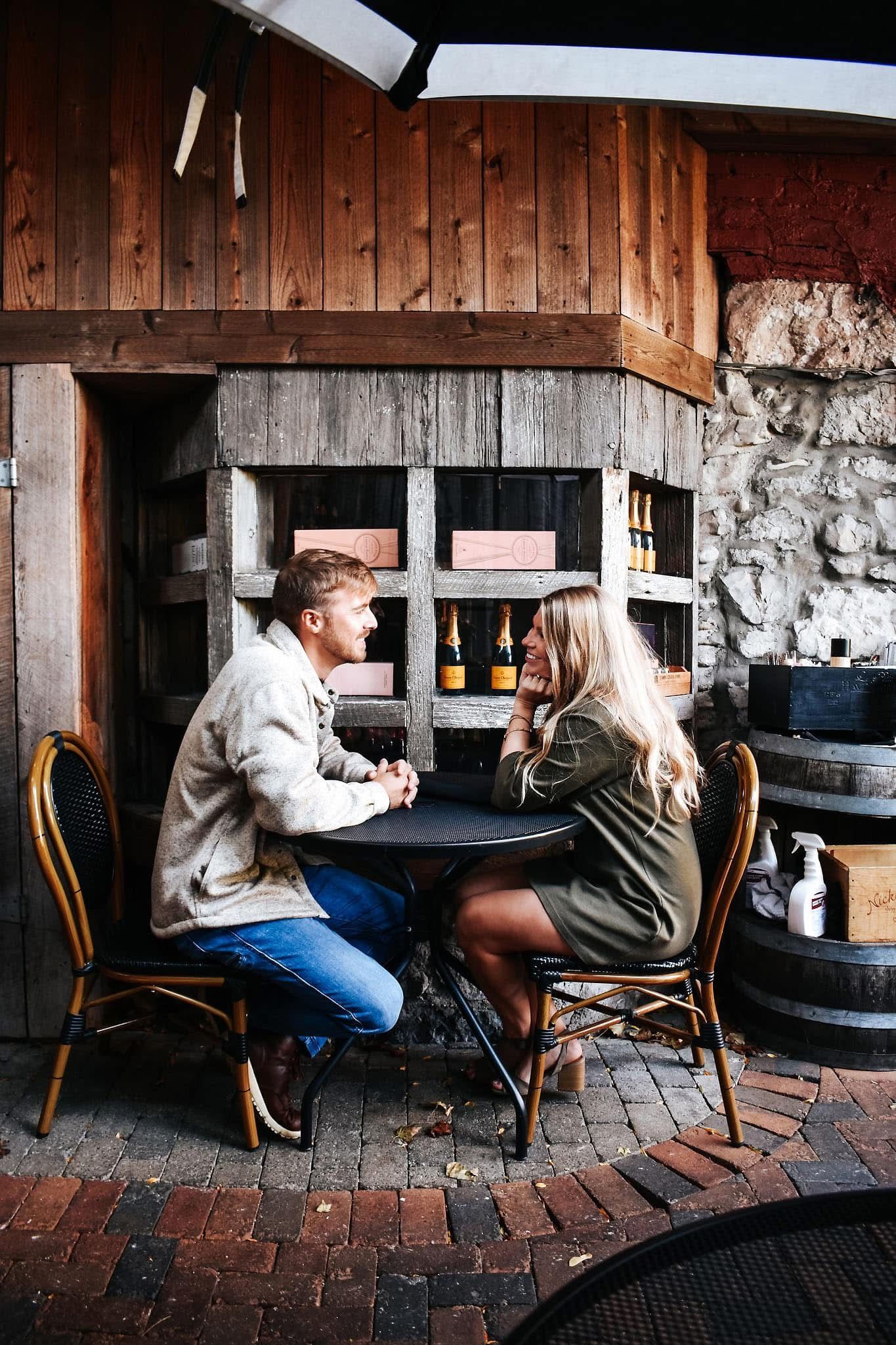 A man and a woman are sitting at a table in a restaurant.