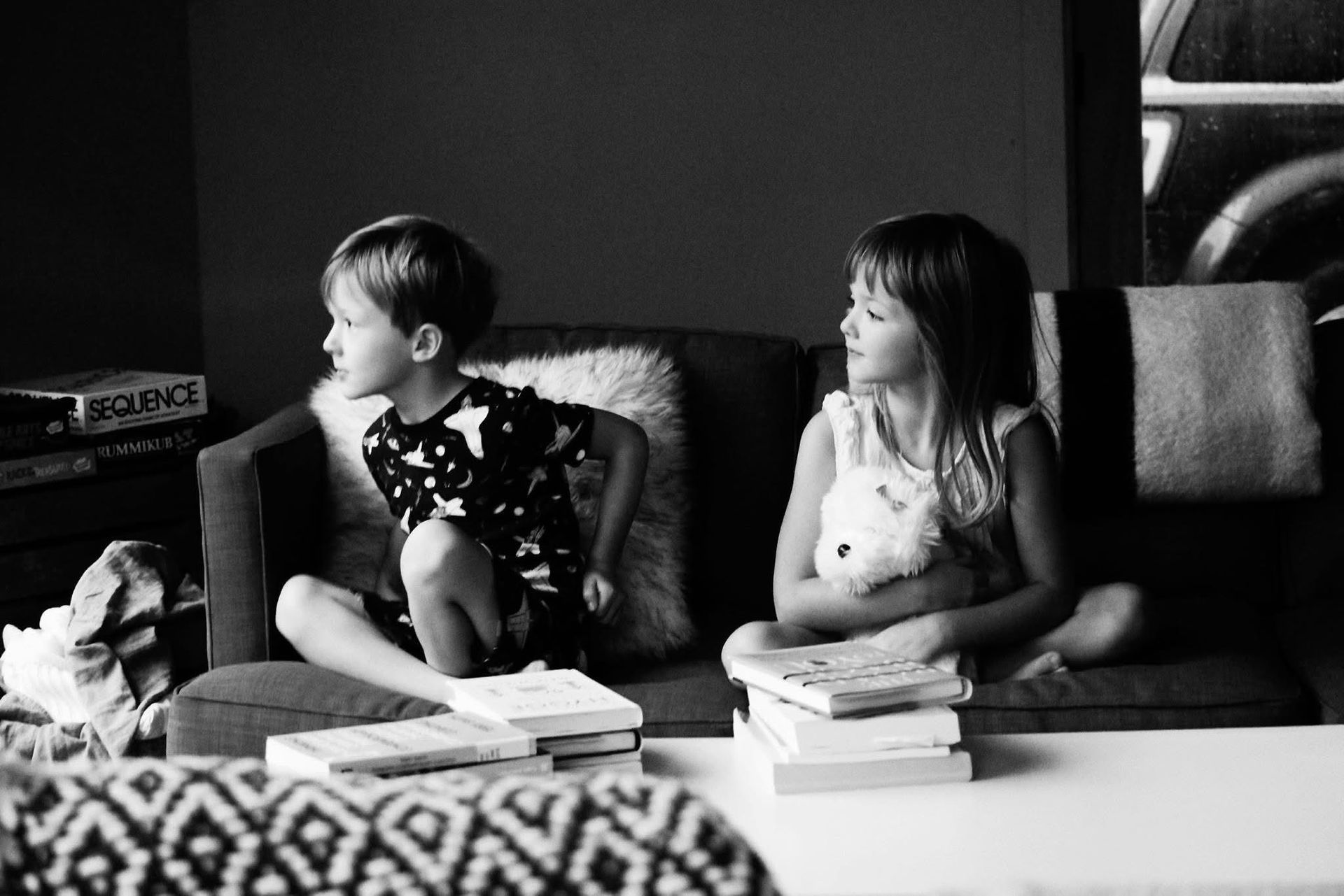 A boy and a girl are sitting on a couch.