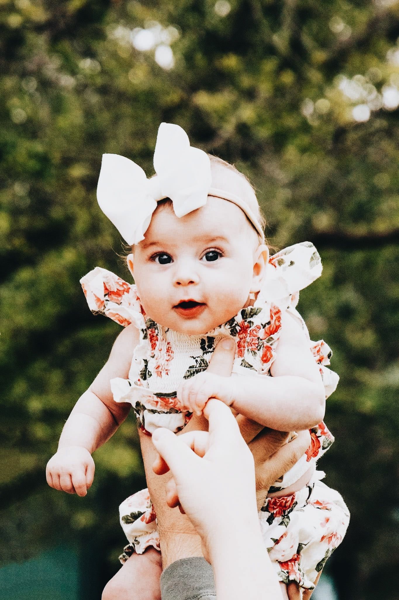 A woman is holding a baby in her arms.