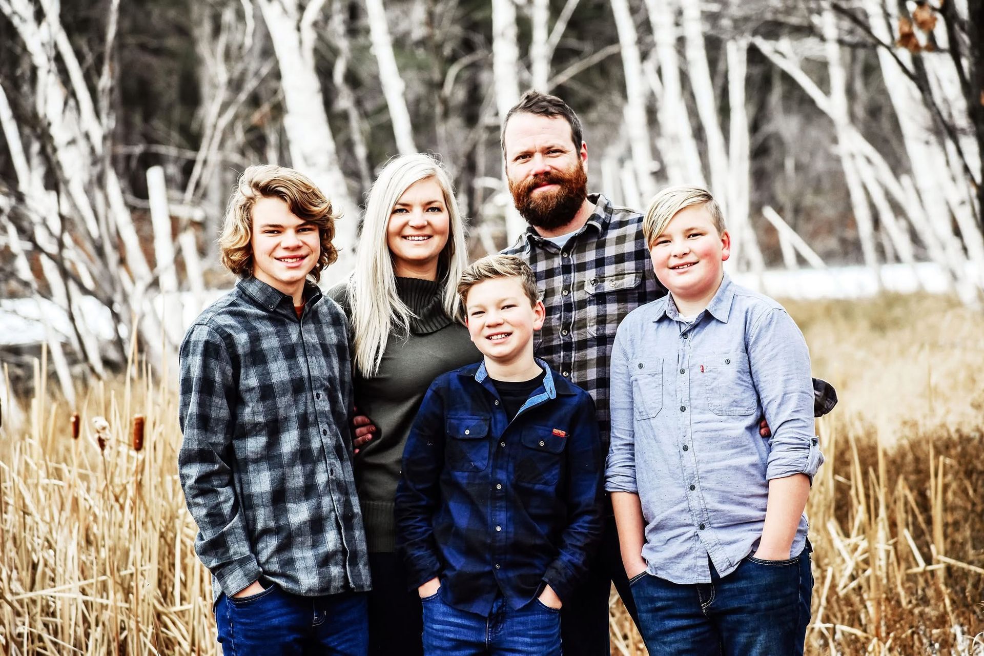 A family is posing for a picture in a field.