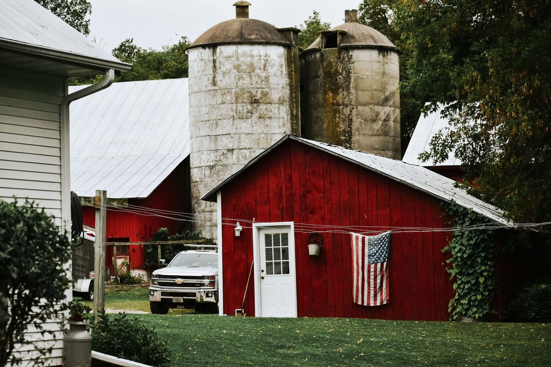 A red barn with an american flag hanging on the clothes line