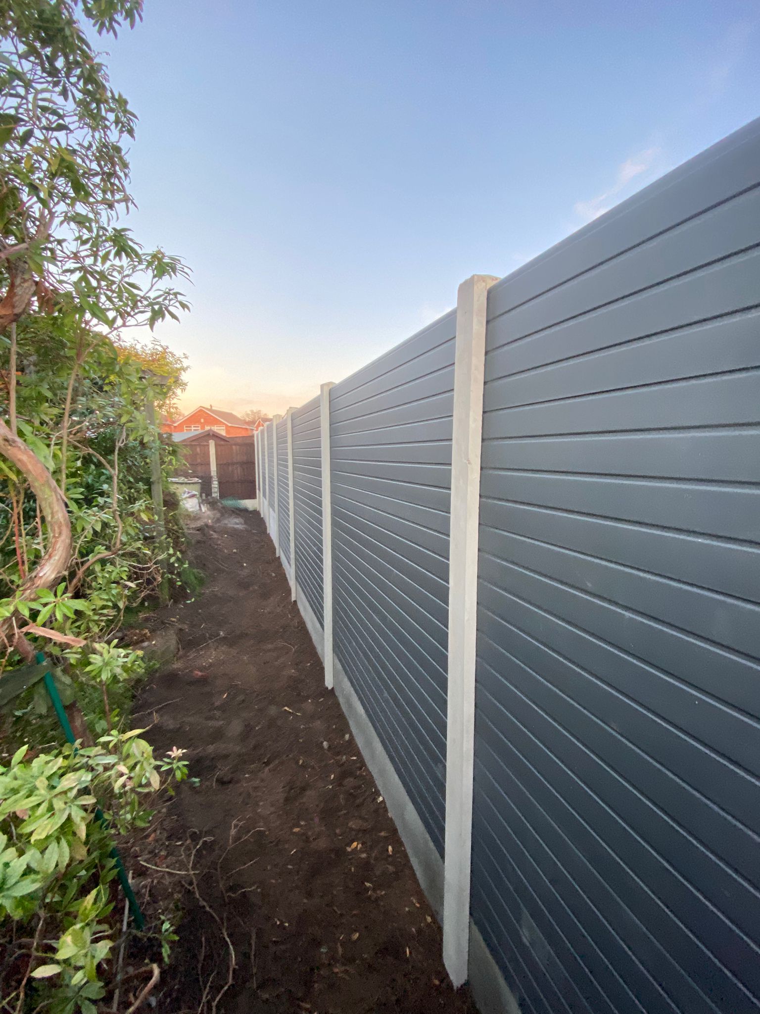 grey composite fence panels in concrete posts