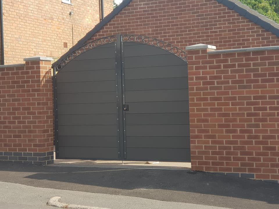 Nottingham Fencing arched composite driveway gates with decorative metal frame top