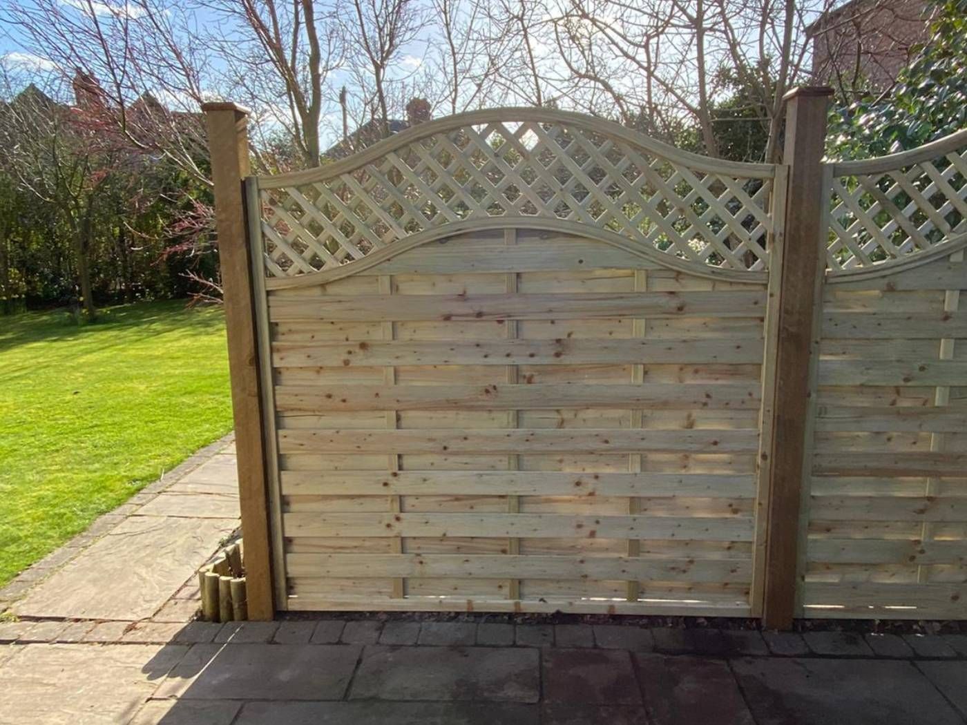 Arched trellis top fencing installed around a patio in Burton Joyce