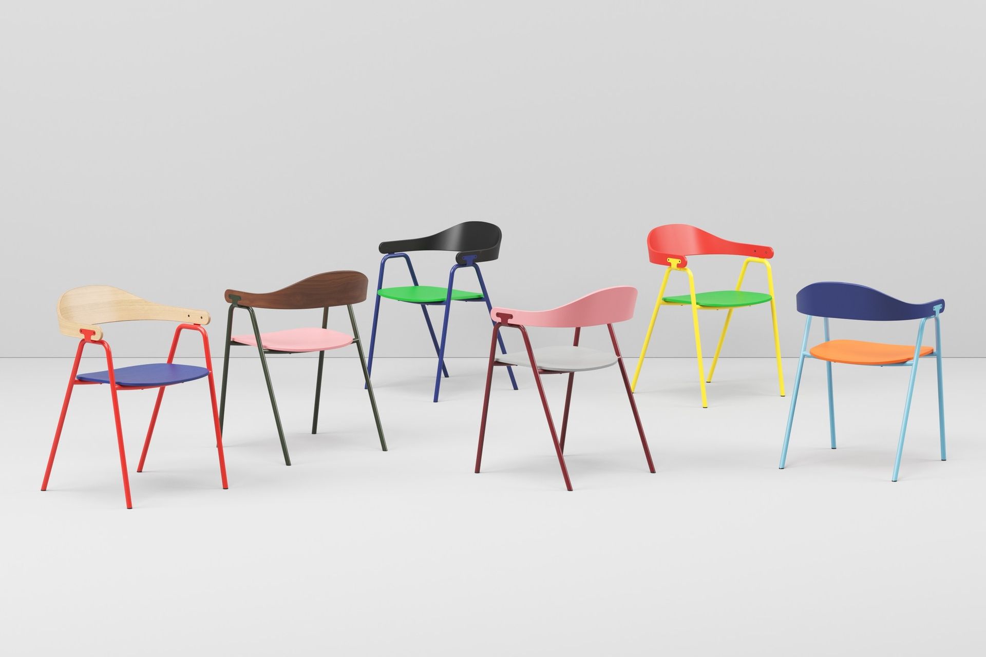 Six colourful Otto chairs situated in a white/grey studio space