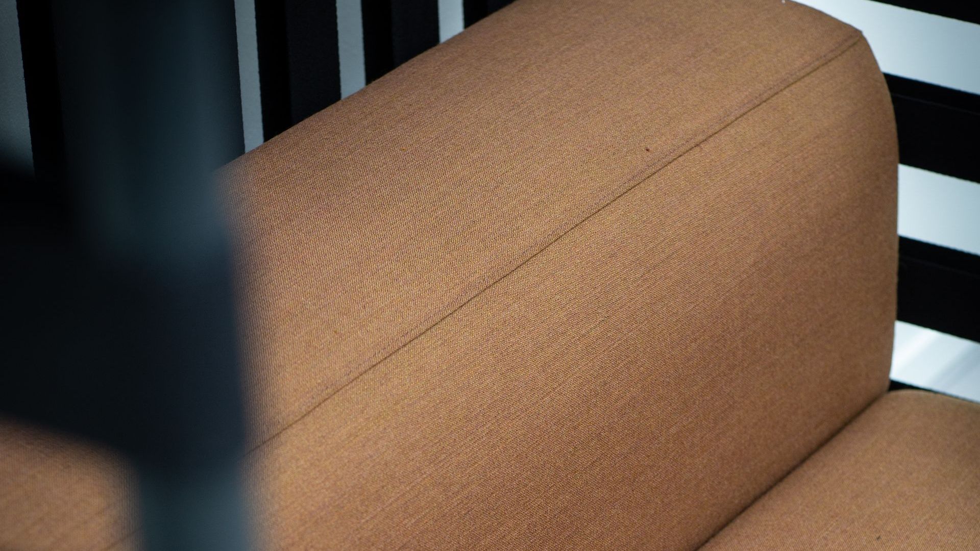Close up of a peach-toned sofa. 