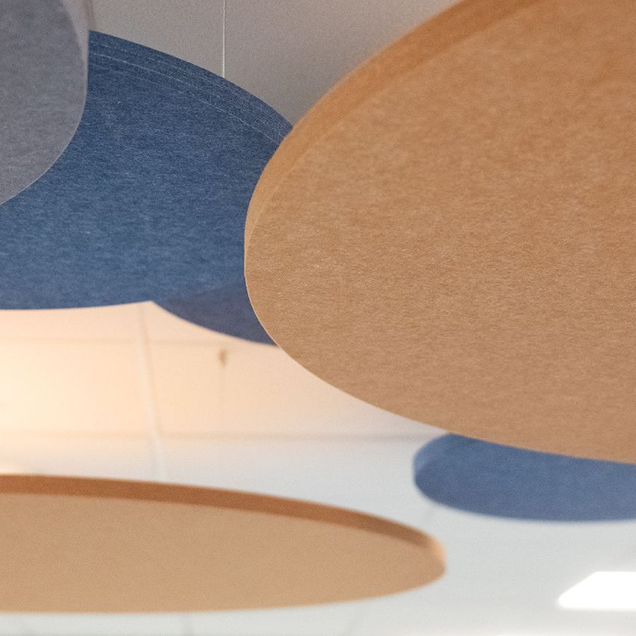 Close up photo of blue and orange hanging acoustic panels.