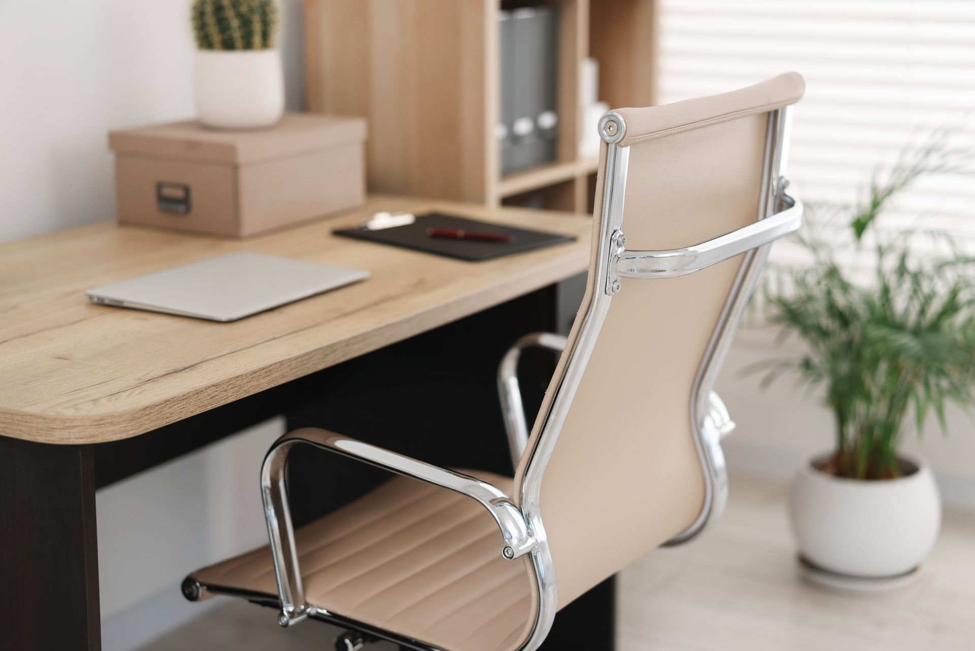 A refurbished leather Vitra Eames chair at a second-hand wooden desk 