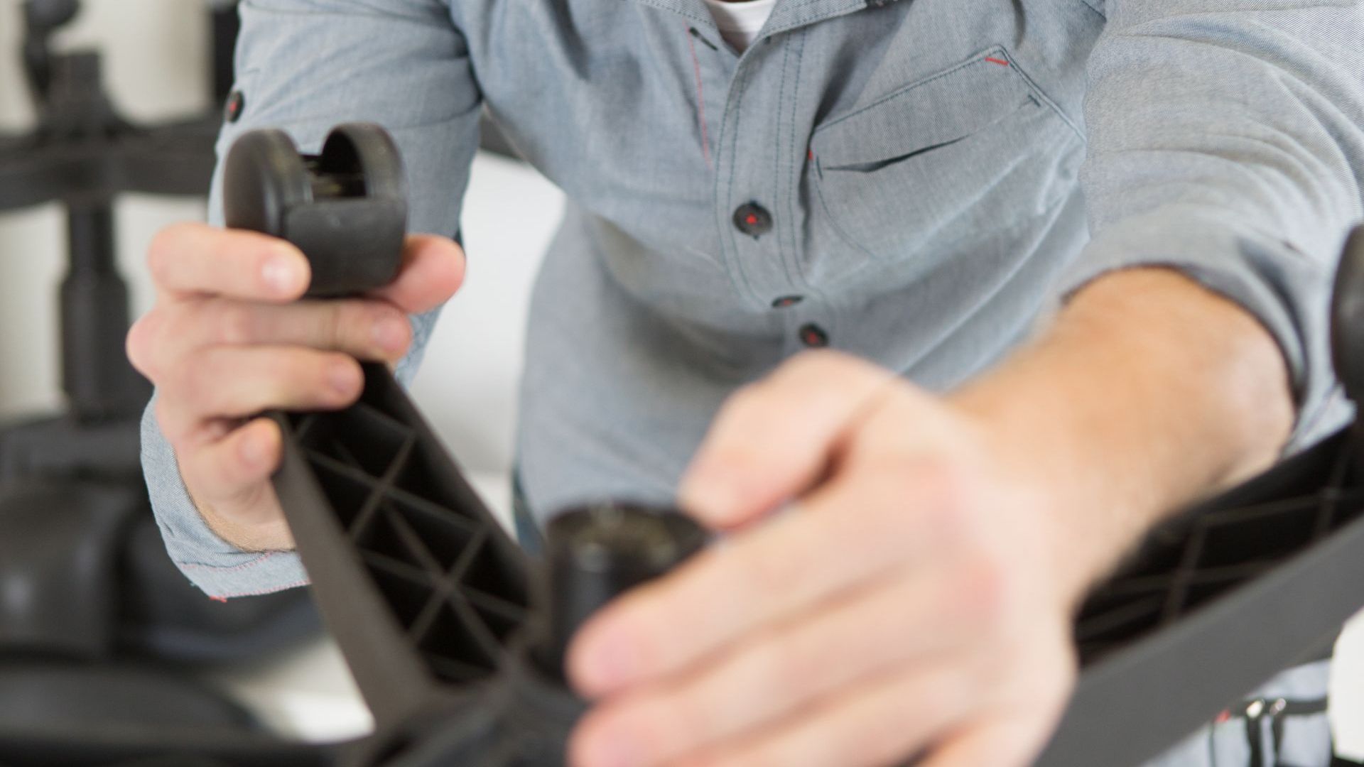 An office chair is repaired by a man in the RefurbHub