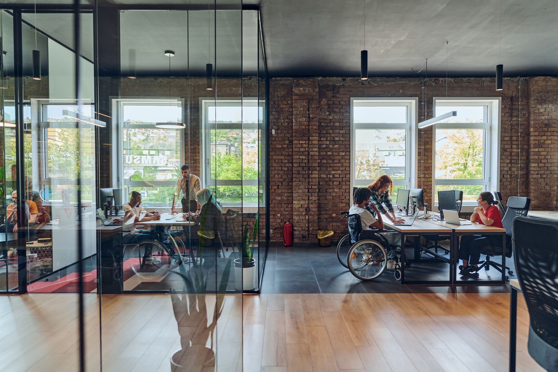 modern workplace with bench desks with space for both office chairs and wheelchair users