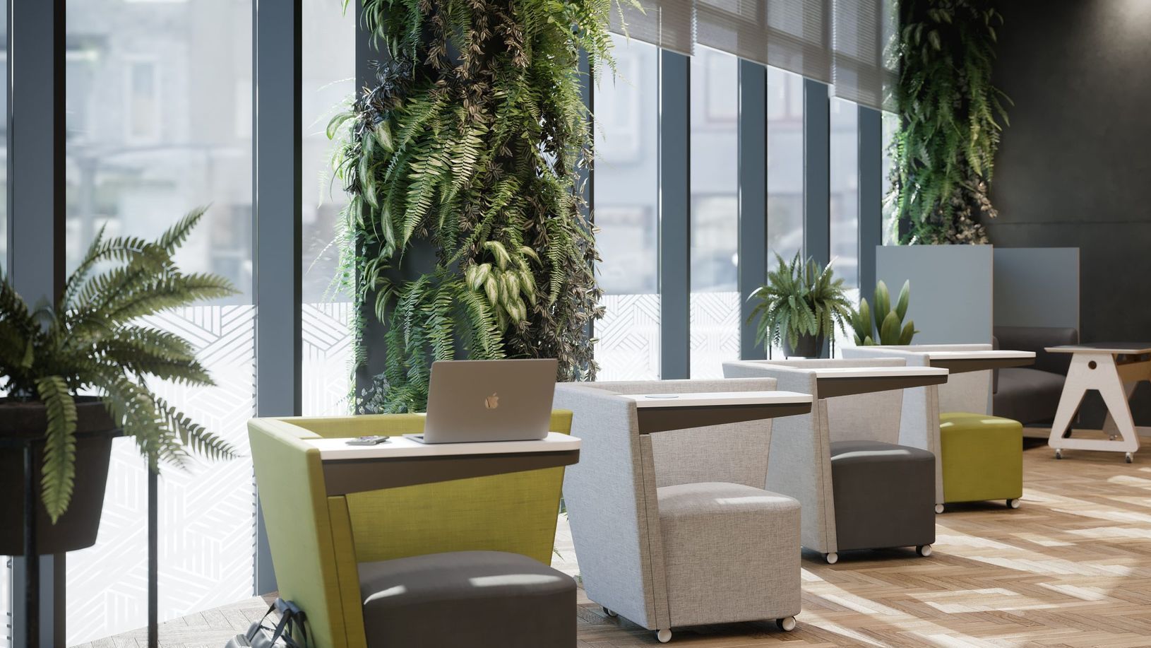 the photo features a window wall in an office. there are individual seating along the windows, each with a personal desk. on the front desk is a laptop. behind the desks are thriving greenery going up the walls and a few plants. 