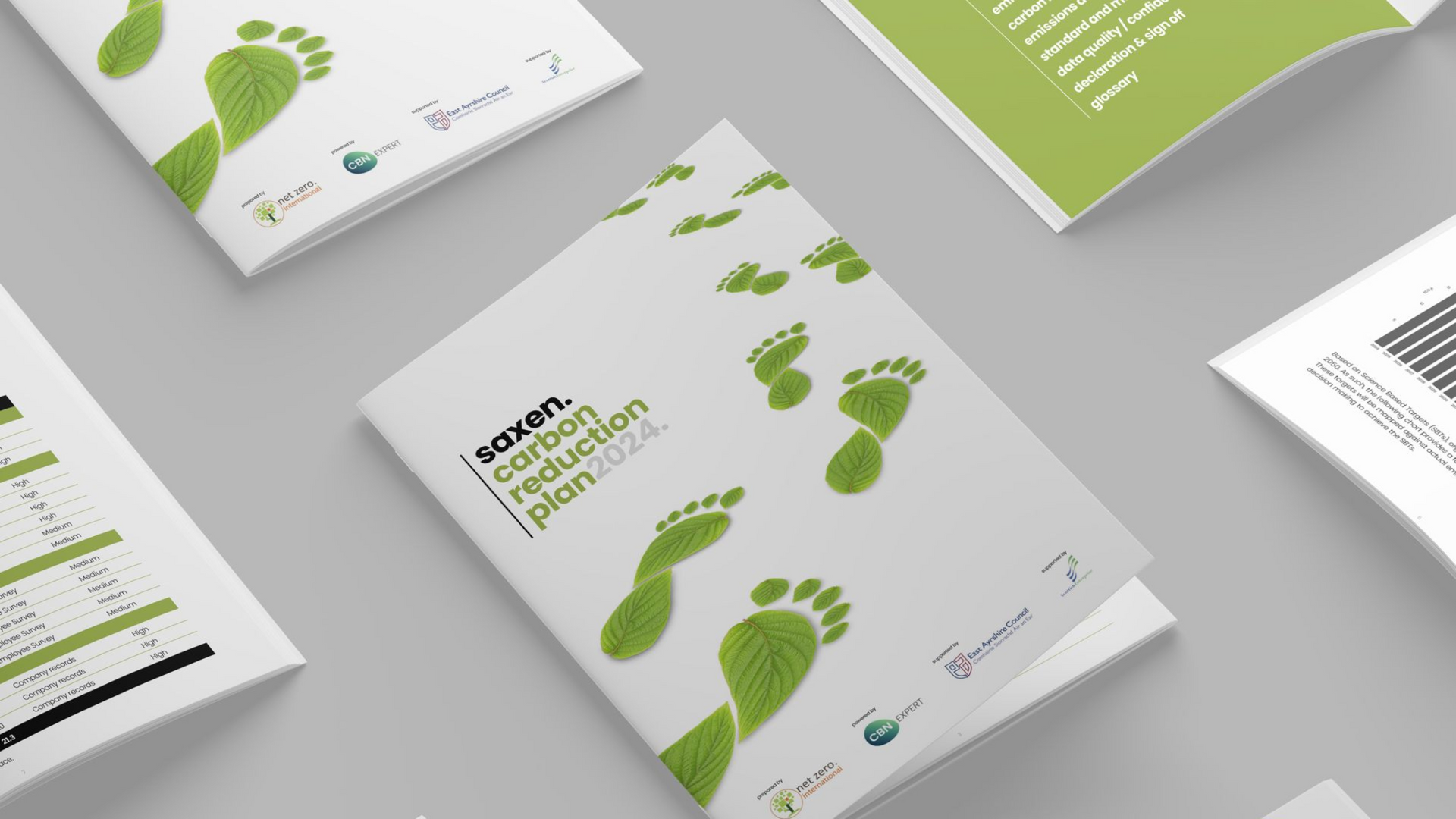 Brochure on wood table next to plant pot. Text: 