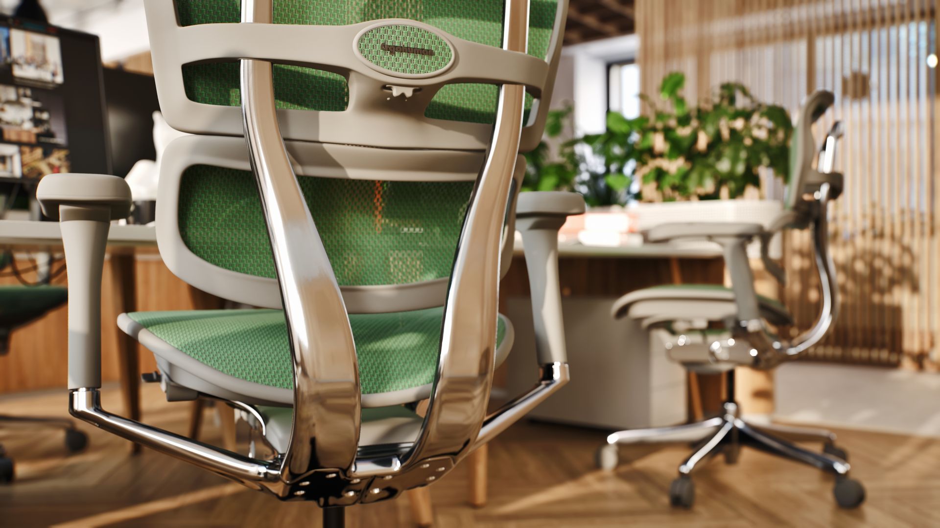 Green and silver ergonomic office chair in a bright office.