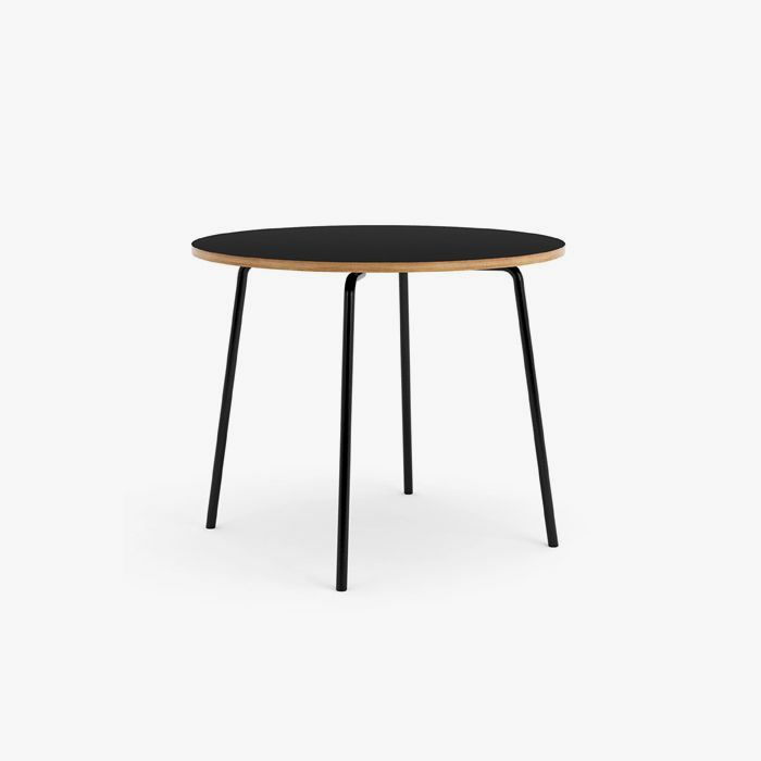 Black round table with black legs on white background.