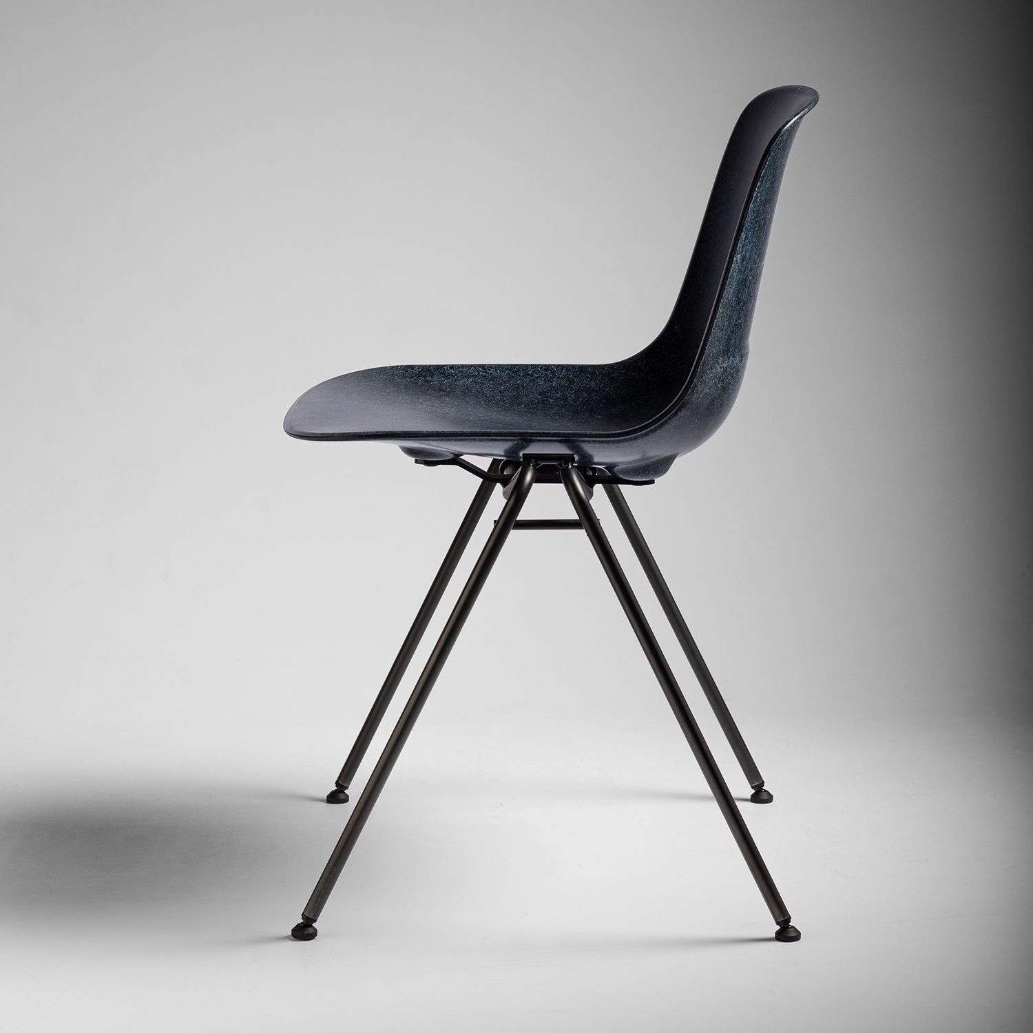 Ink Welsh Mountain Hembury chair with black steel legs facing left.
