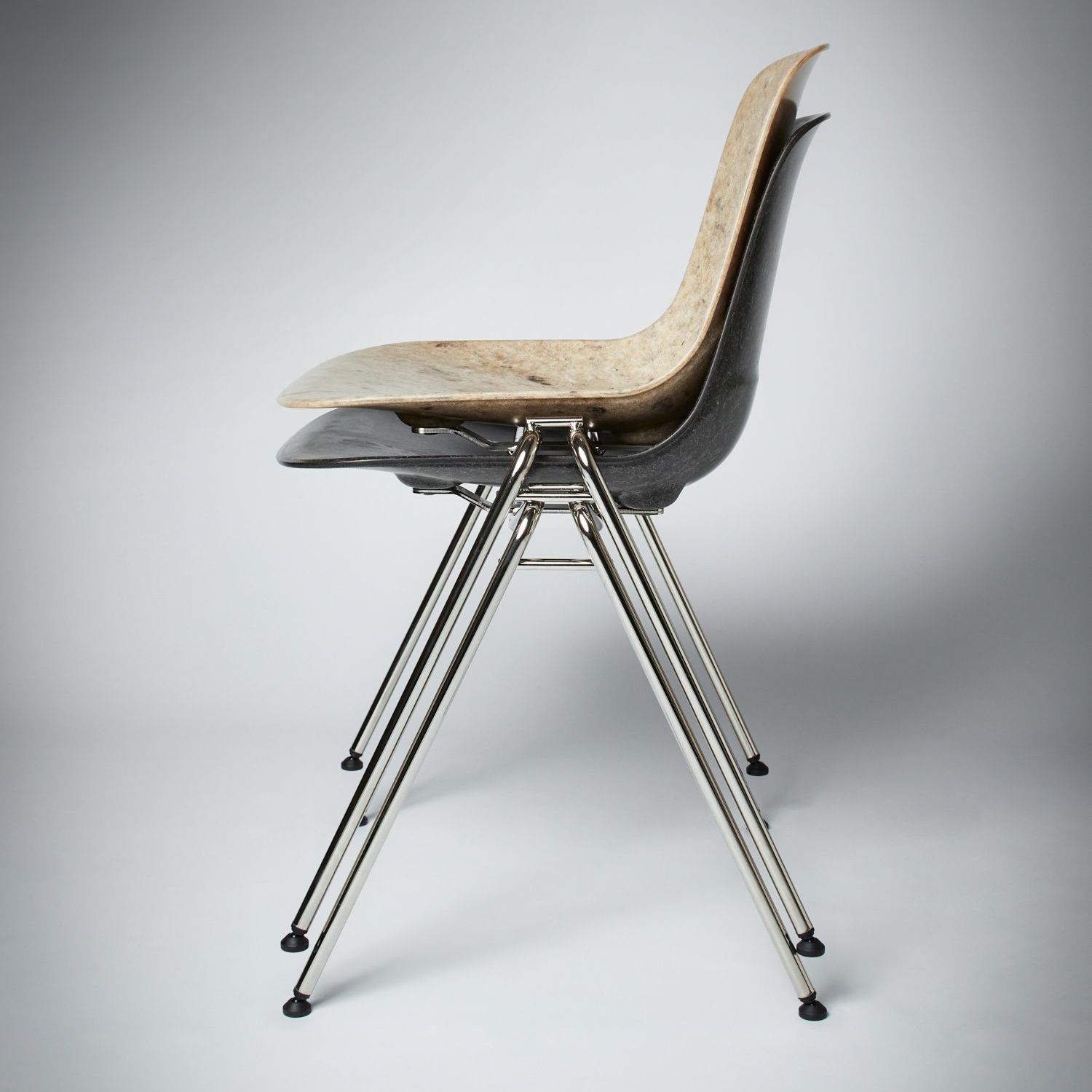 Two stacked Hembury chairs facing left, both featuring chrome plated steel legs.