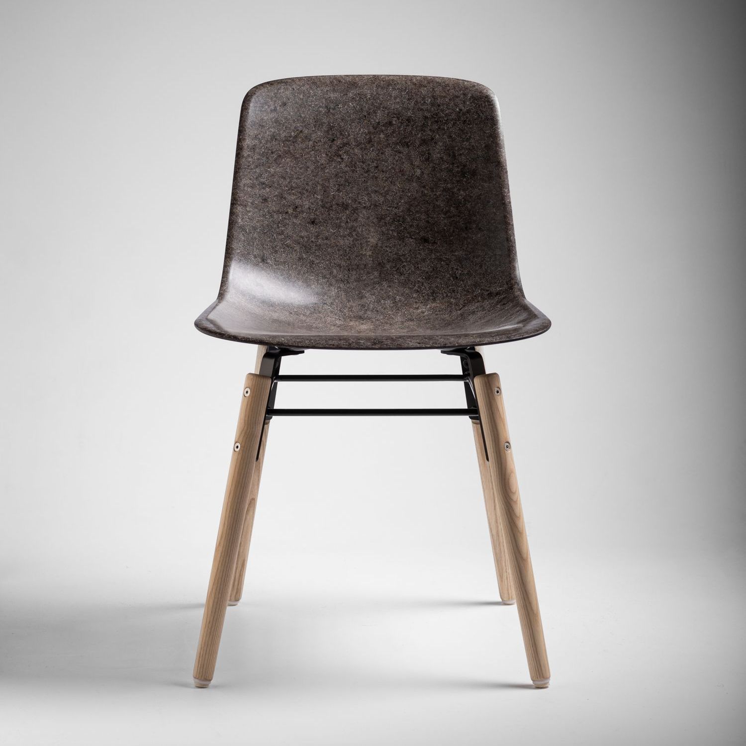 Stone Welsh Mountain Solidwool chair with oiled ash legs facing front.