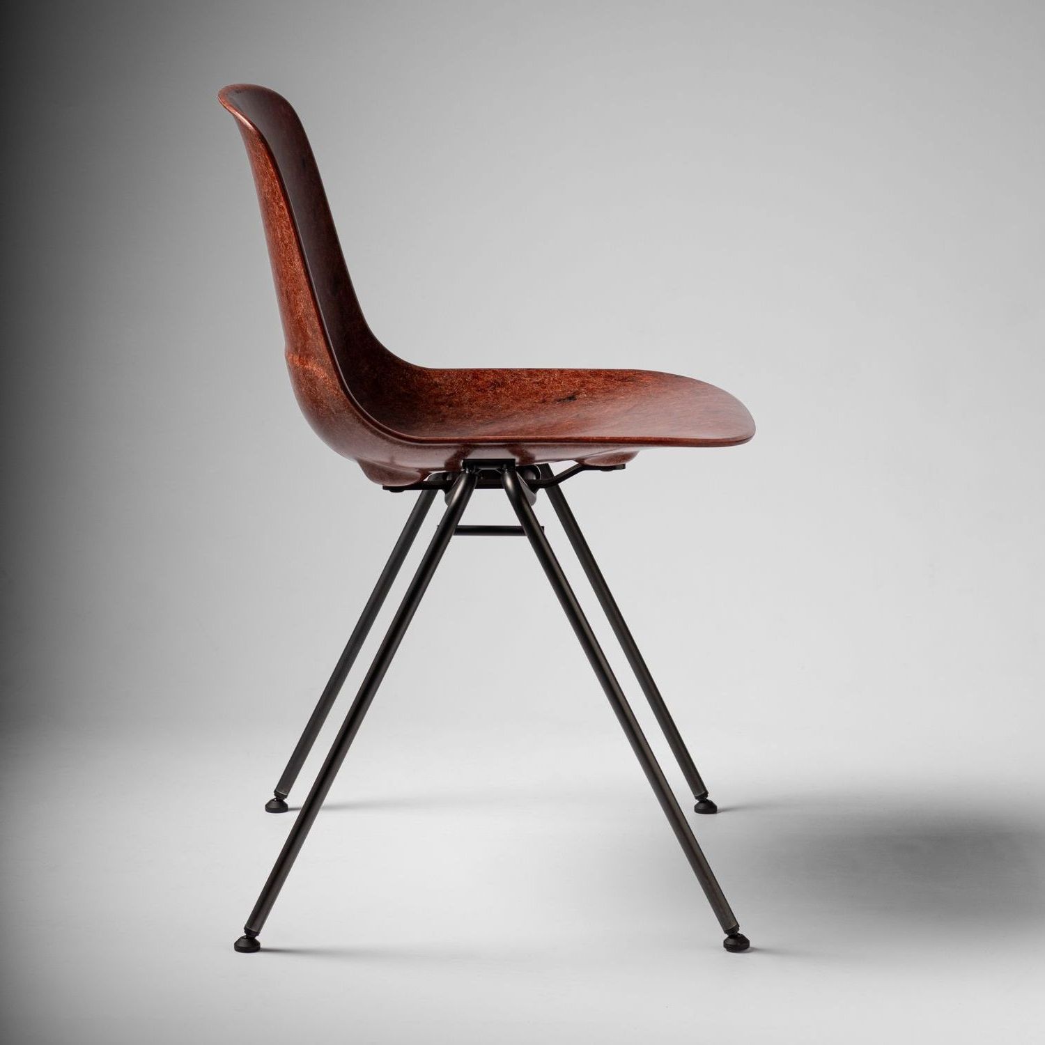 Tan Welsh Mountain Hembury chair with black steel legs facing right.