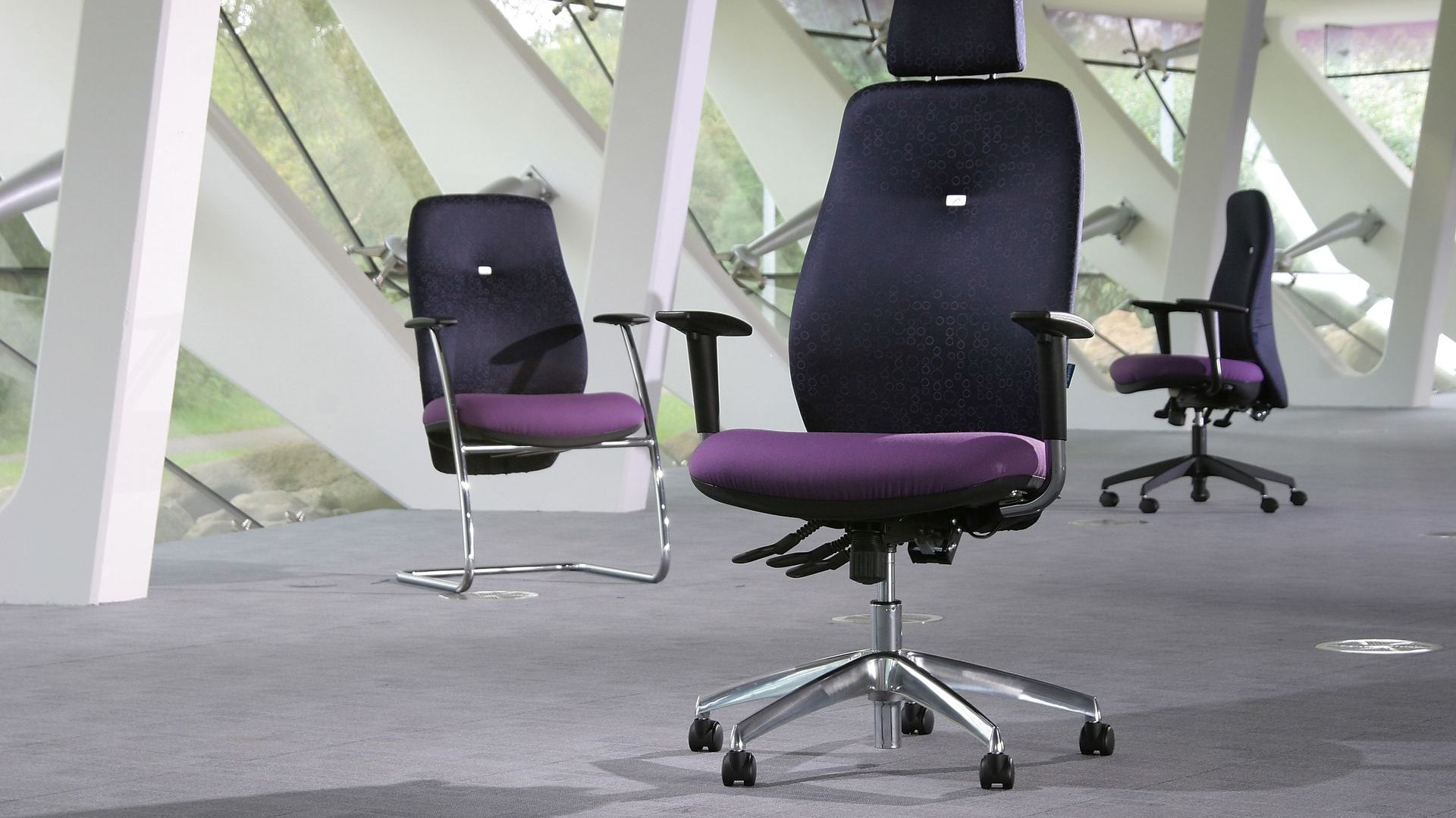 summit inflexion chairs in a large studio space. the chair seats are purple and the back of the chairs are a dark indigo colour. 