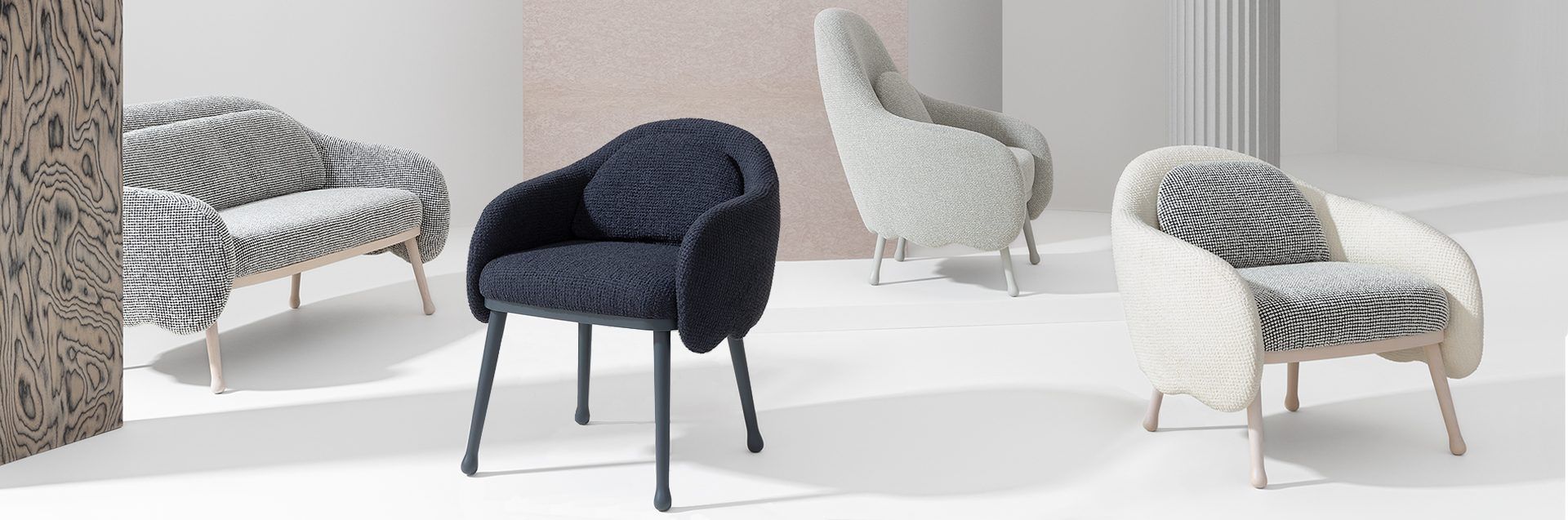 Four modern armchairs in a neutral-toned room, each with a different texture: striped, dark blue, light grey, and zebra.
