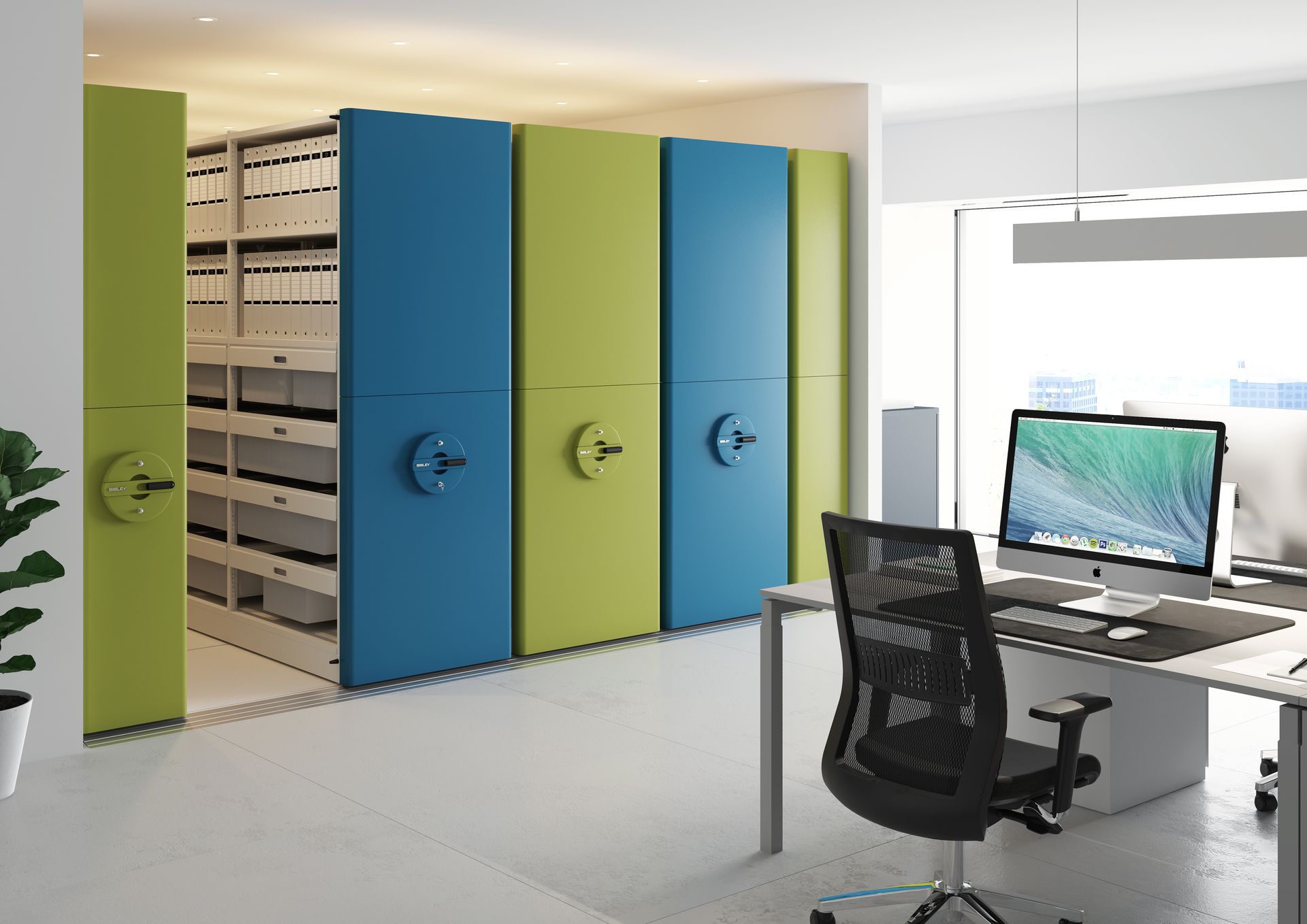 Office with colorful rolling steel storage cabinets, desk, and computer.