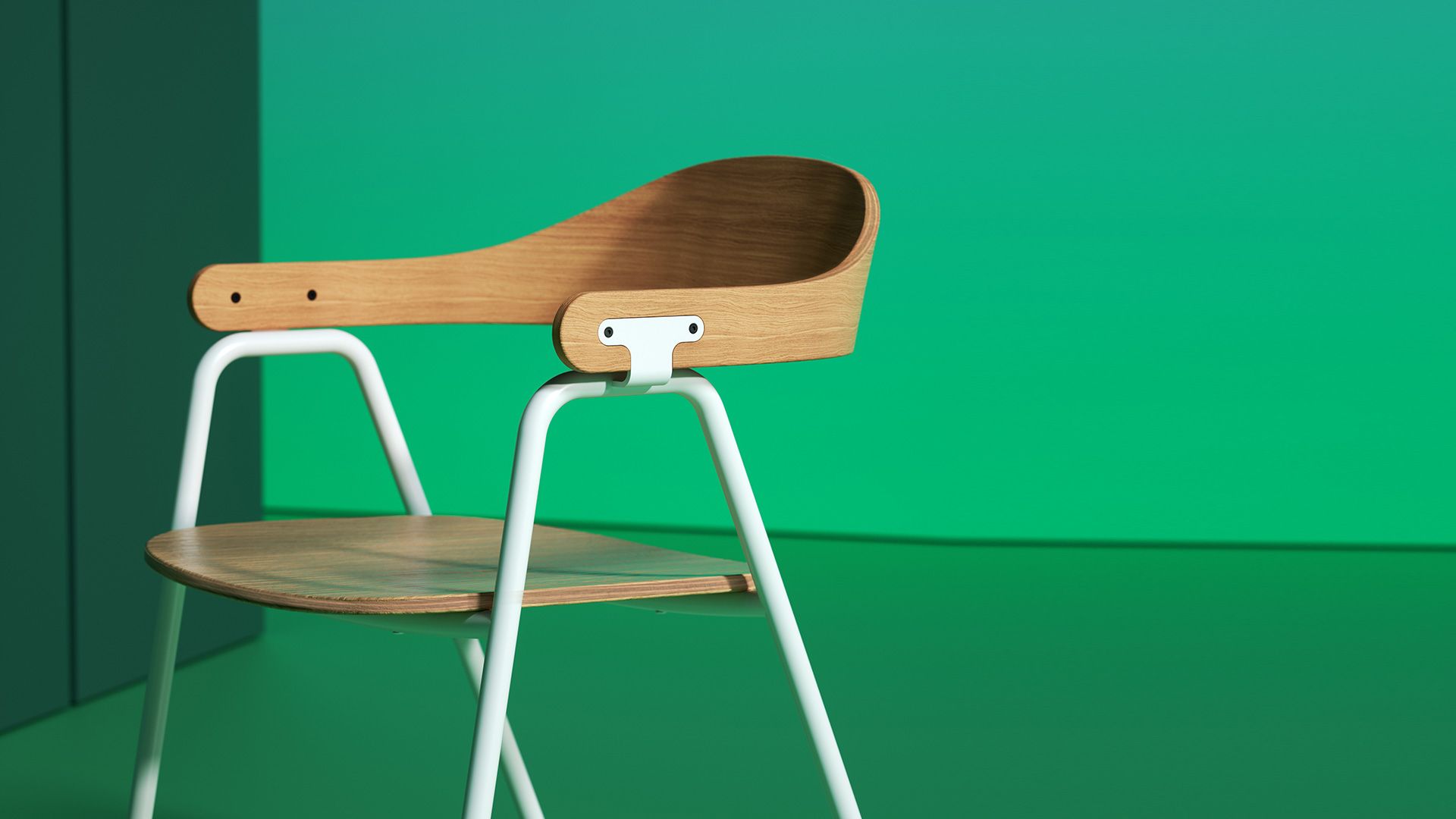 A modern chair with a wooden seat and back, white metal legs, against a green background.