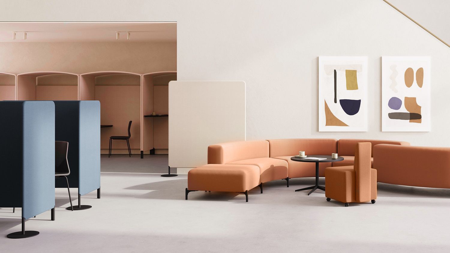 To the left of the image are FourPeople huts in a peach tone. To the right of the image is a peach rounded sofa at a black table. On the wall is modern abstract artwork. 