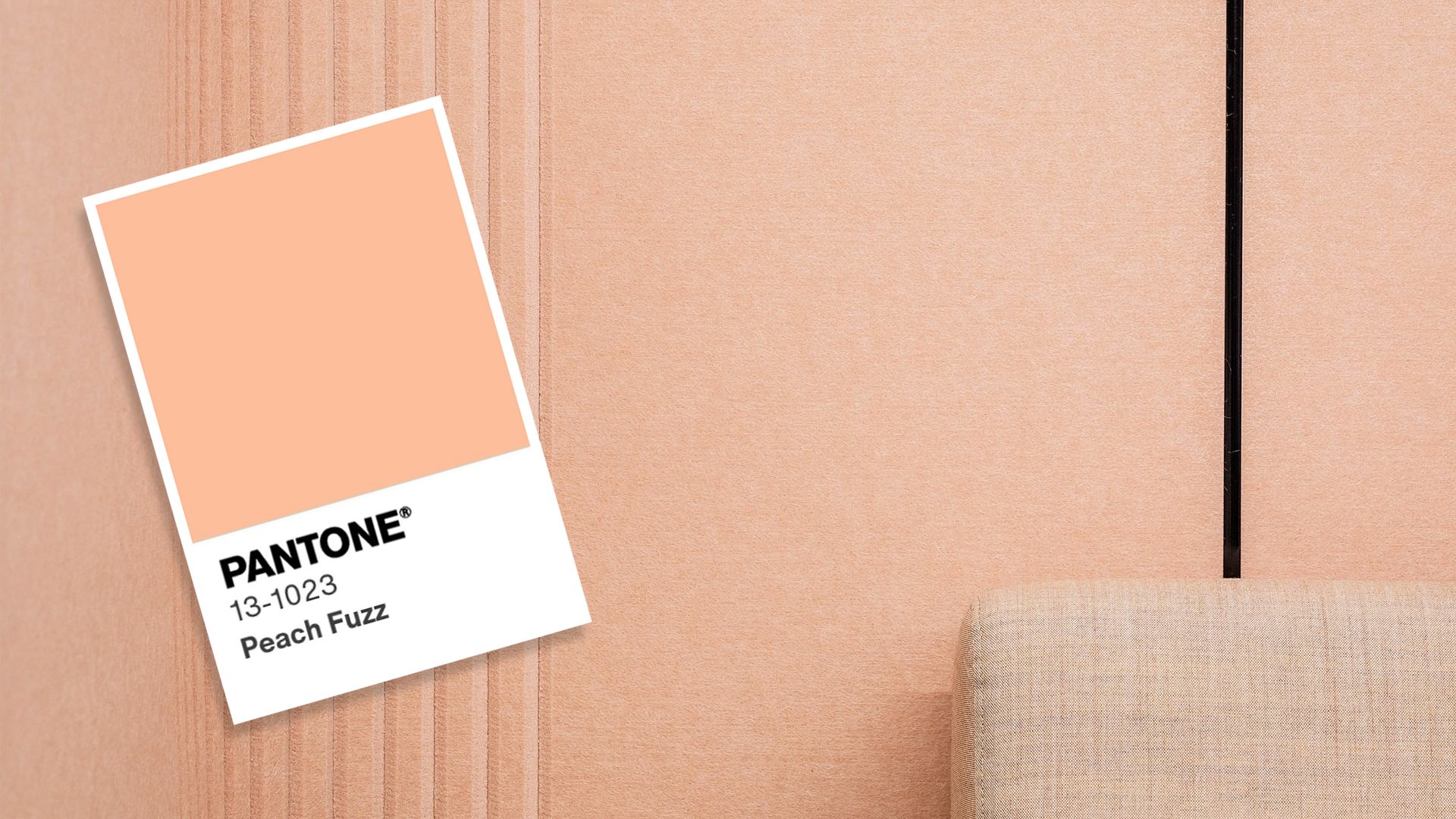 Peach coloured wallpaper with a peach-toned couch. The Pantone peach colour card is edited on top of the image. 