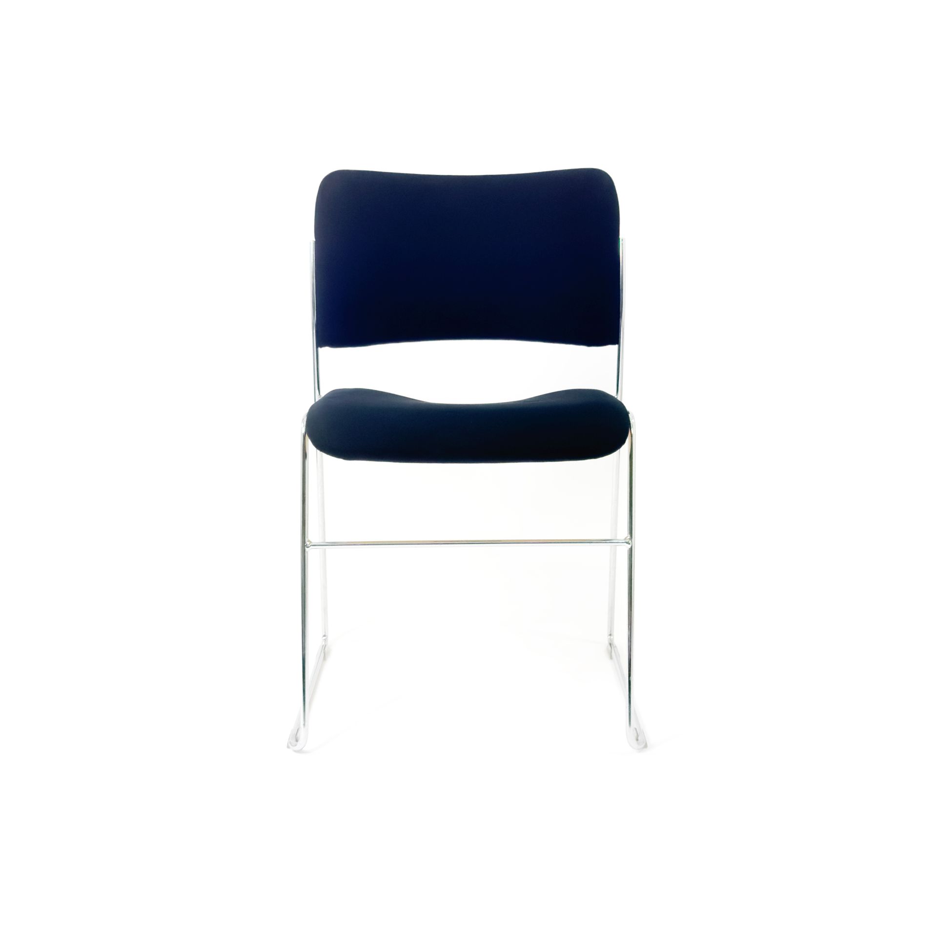 Blue upholstered chair with a silver frame, isolated on white.