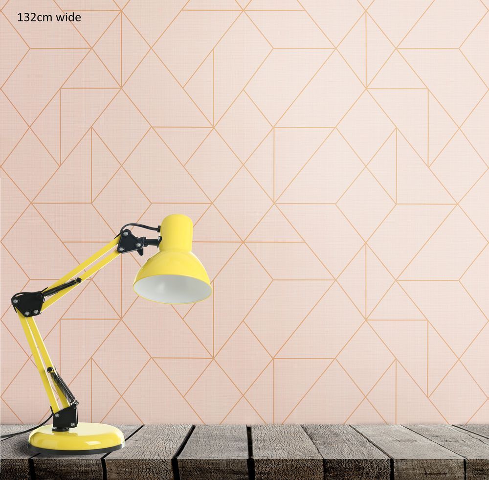 Geometric peach wall-paper with a yellow lamp stood before it. 