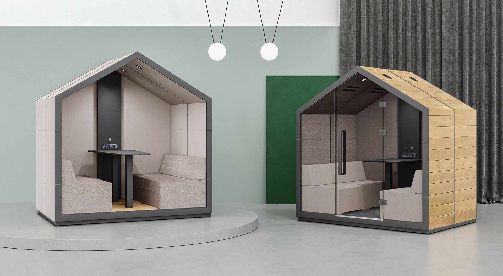 Two house-shaped office pods. One is light with a dark frame, the other is wood-paneled. Both have seating, tables, and lights.