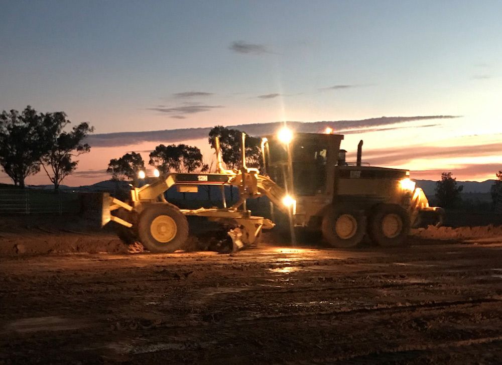 Tractor Grader With Lights Turned On — Earthmoving In Upper Manilla, NSW