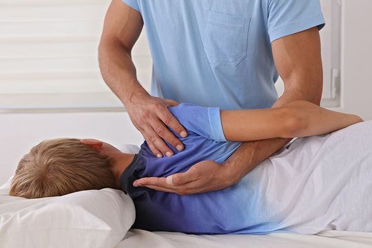 Boy Having Chiropractic Back Adjustment