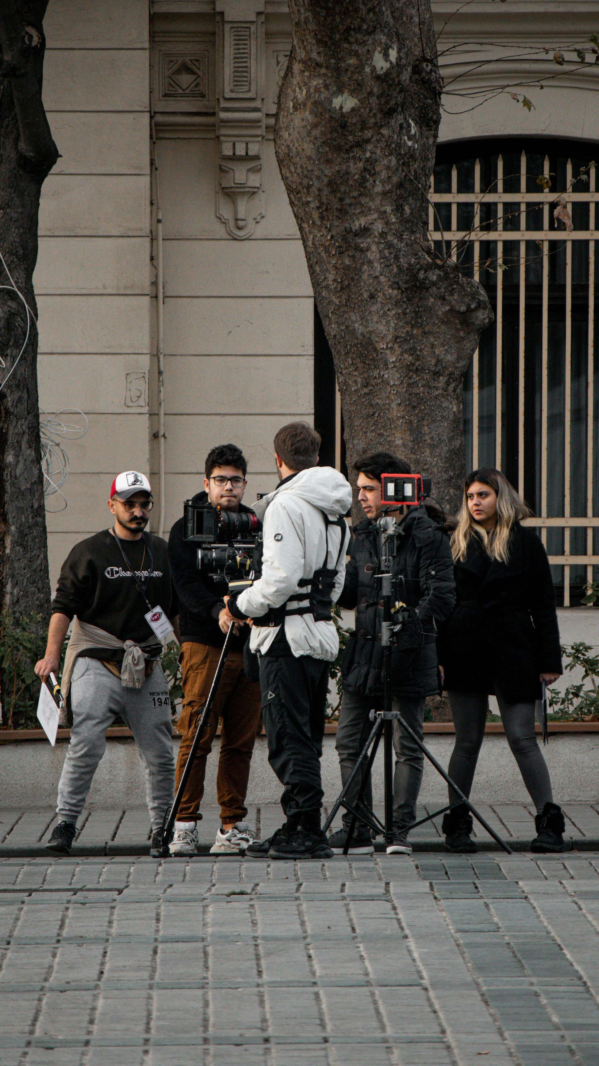Régisseur de tournage sécurisant des emplacements sur une rue parisienne avec panneaux B6