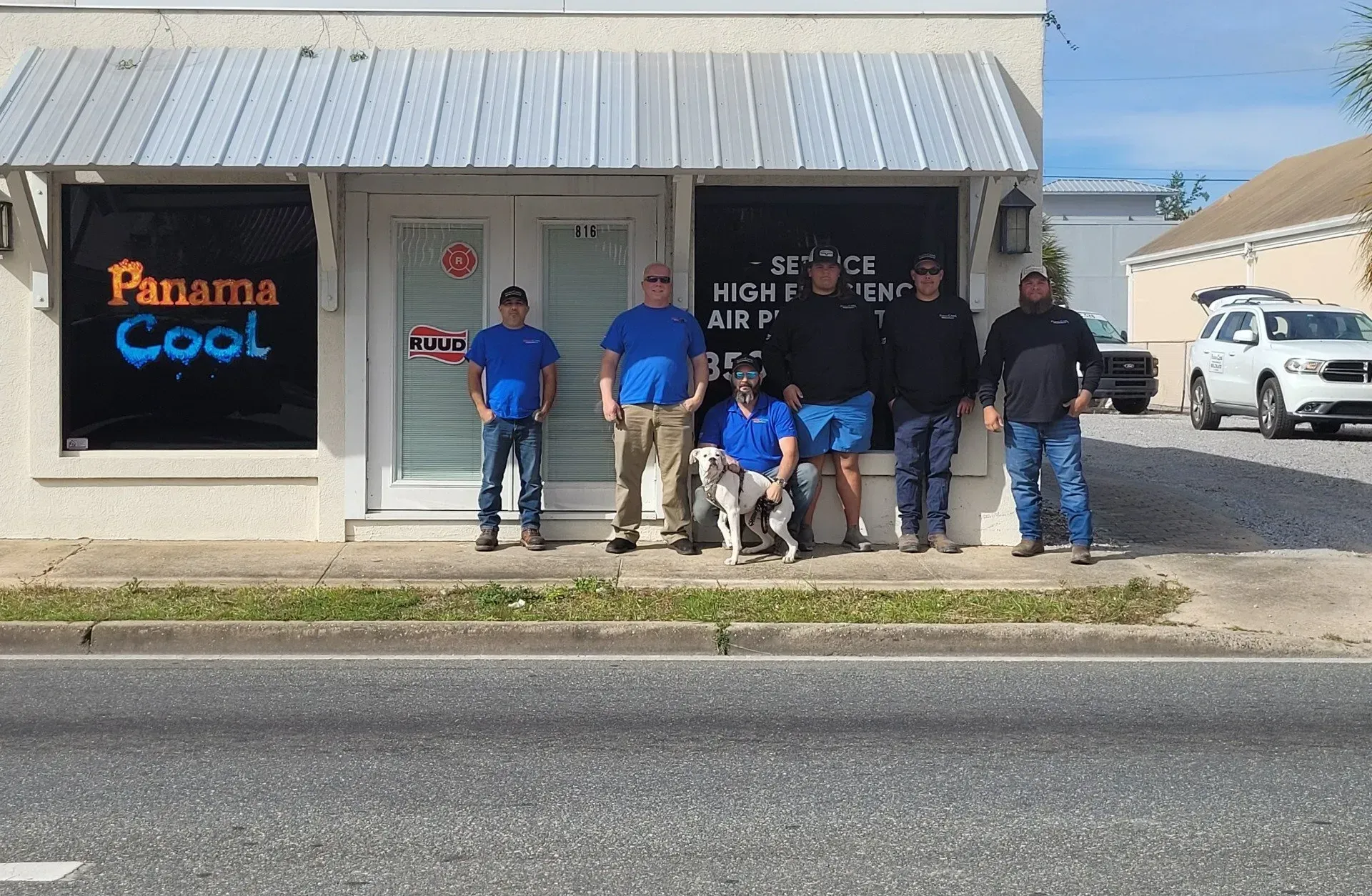 A group of men standing in front of a panama cool store