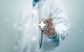 A doctor is holding a magnifying glass with a cross in the middle.