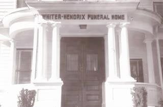 A black and white photo of the entrance to a funeral home.