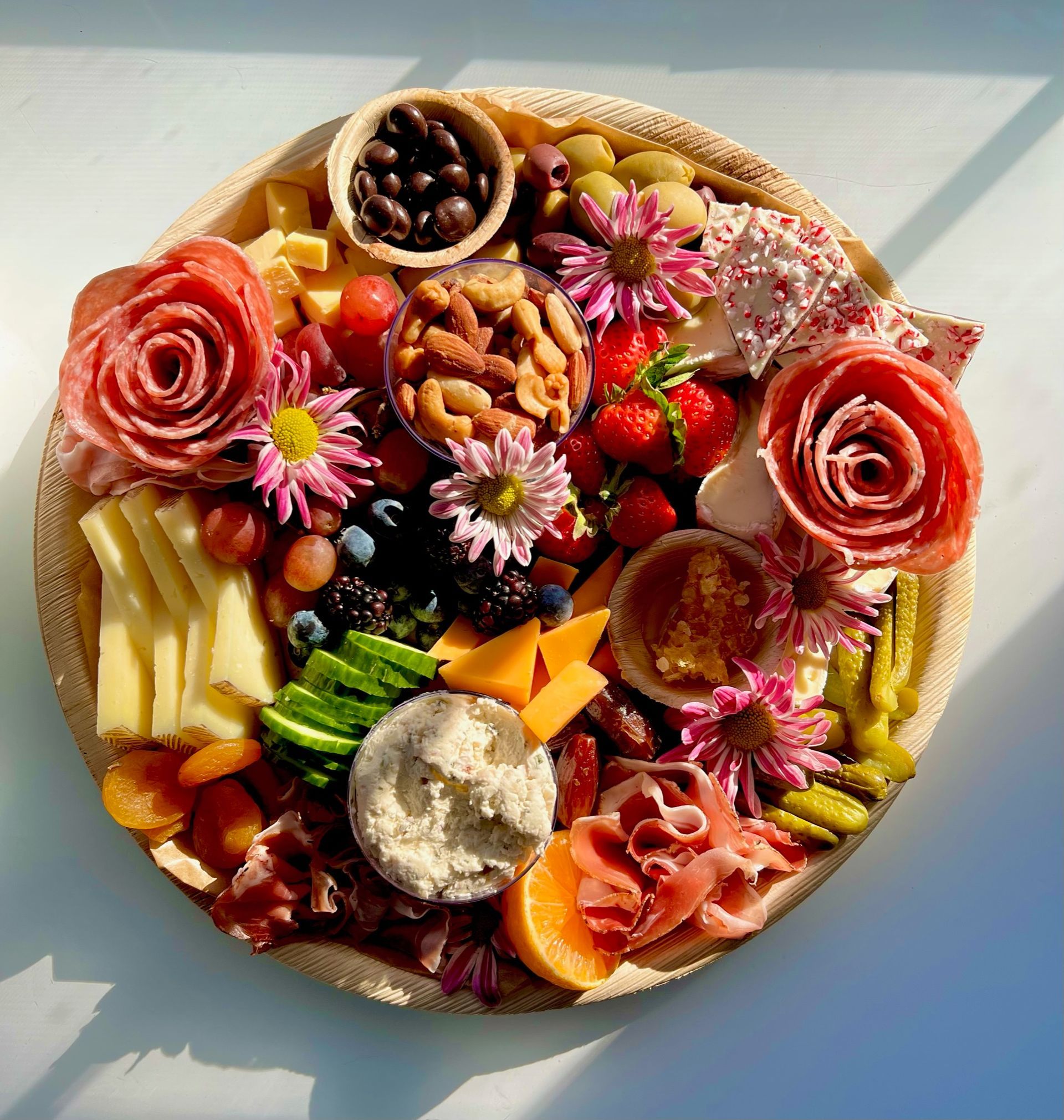A plate of food with flowers and nuts on it