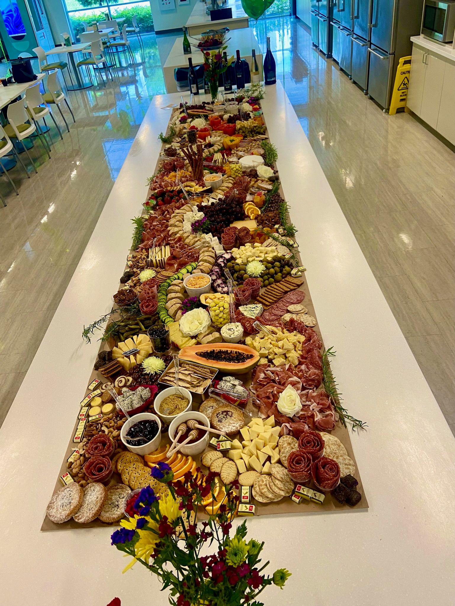 A long table filled with lots of food and flowers.