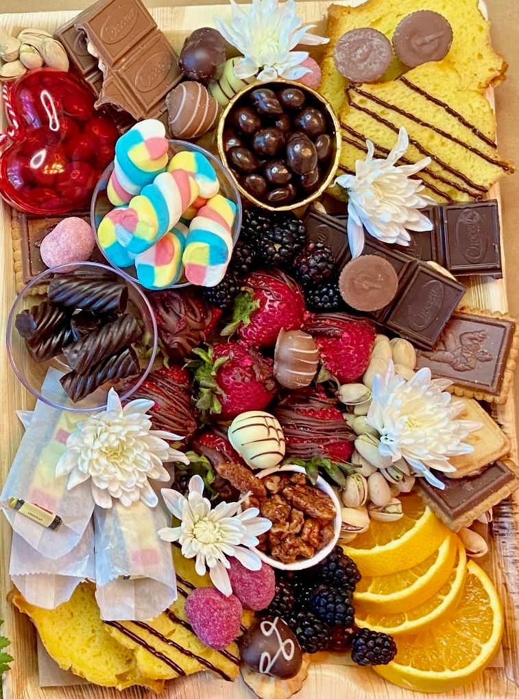 A wooden tray filled with lots of different types of food.