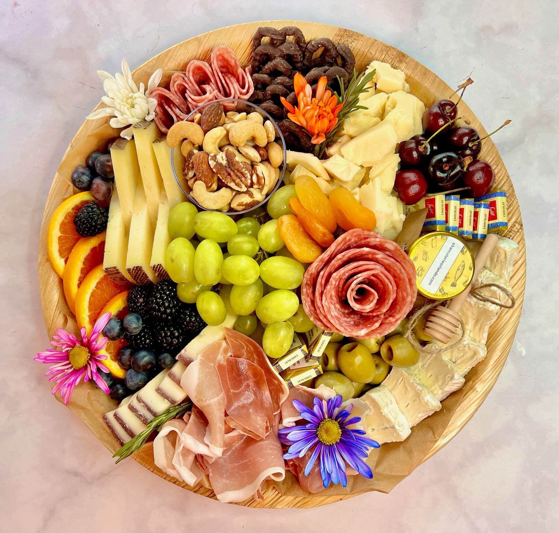 A wooden cutting board filled with lots of different types of food.