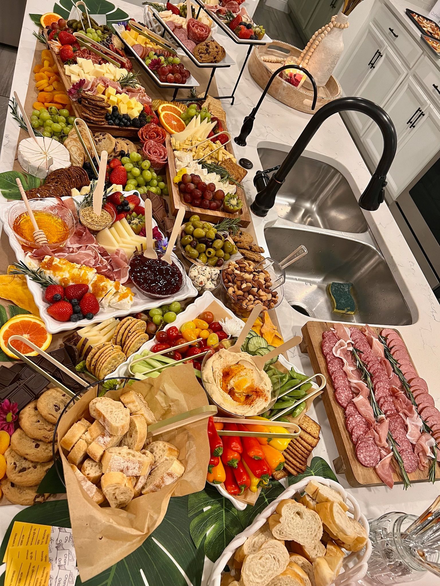 A kitchen counter filled with lots of food and a sink.