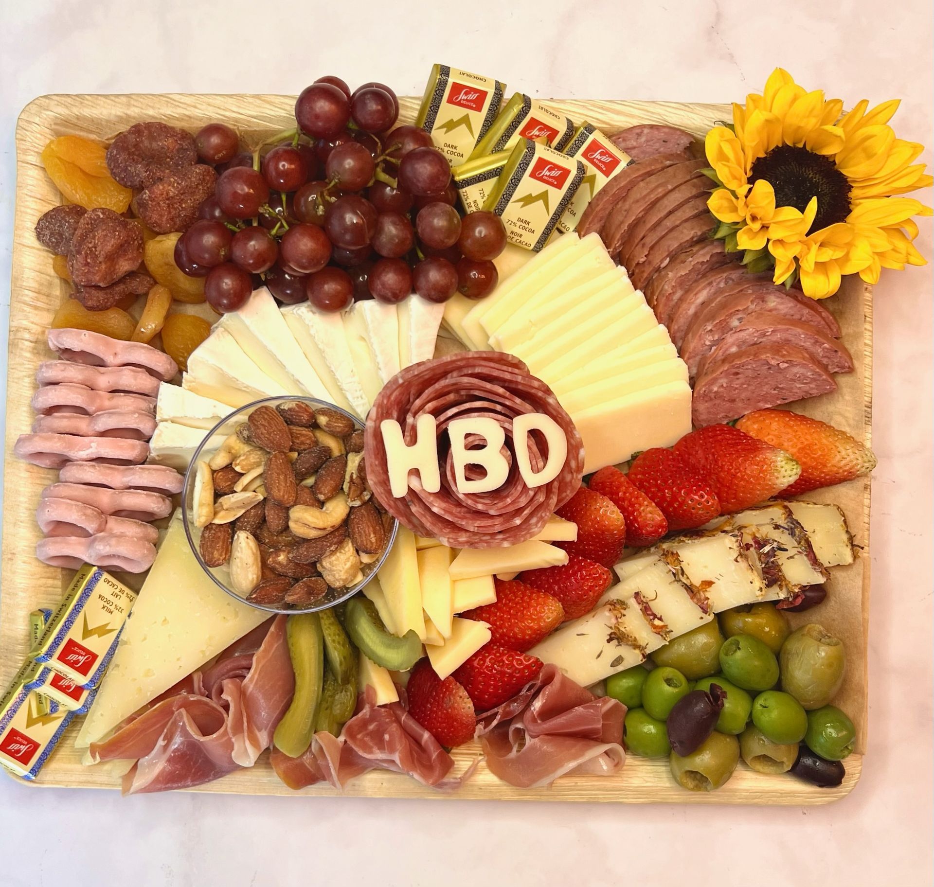 A tray of food with the word hbd on it