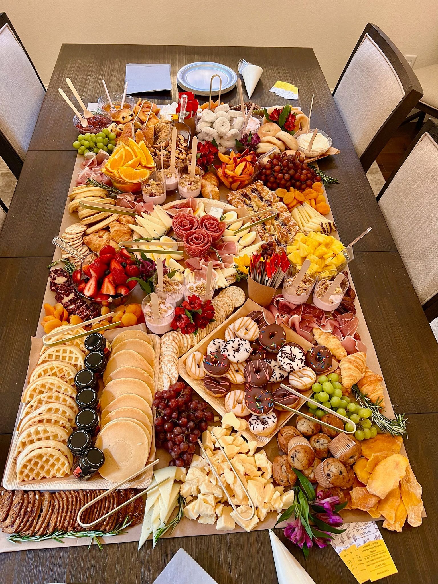 A large tray of food is sitting on top of a wooden table.