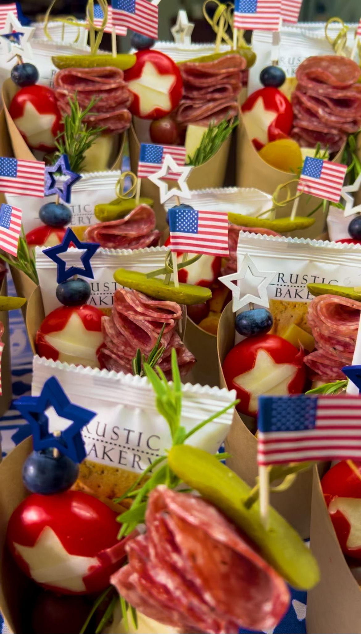 A bunch of boxes filled with food and american flags.