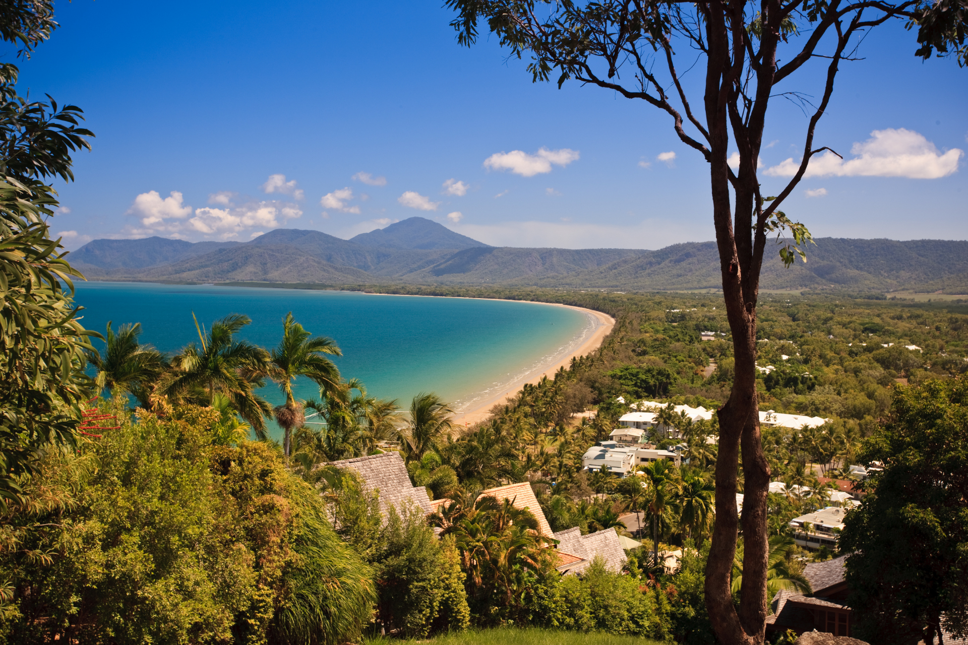 A view of a beach with mountains in the background